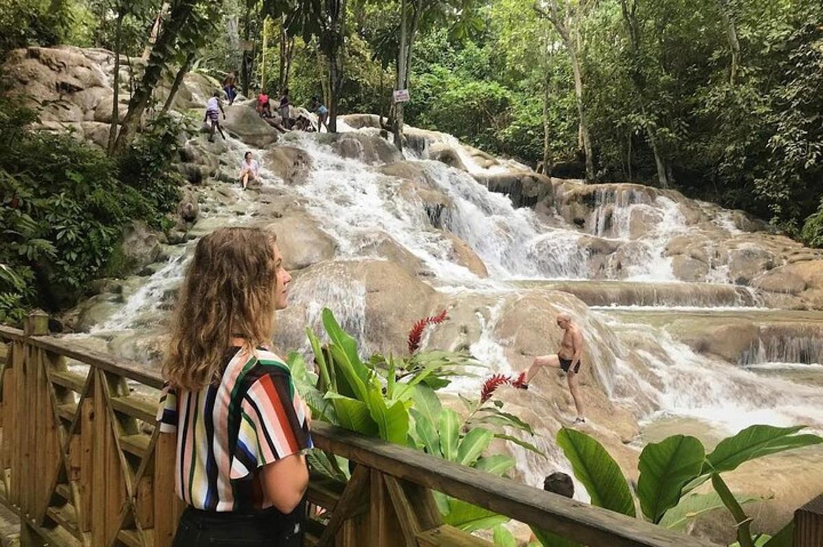 a woman standing in front of a waterfall
