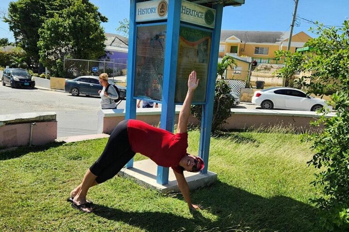 a person doing a handstand at a phone booth