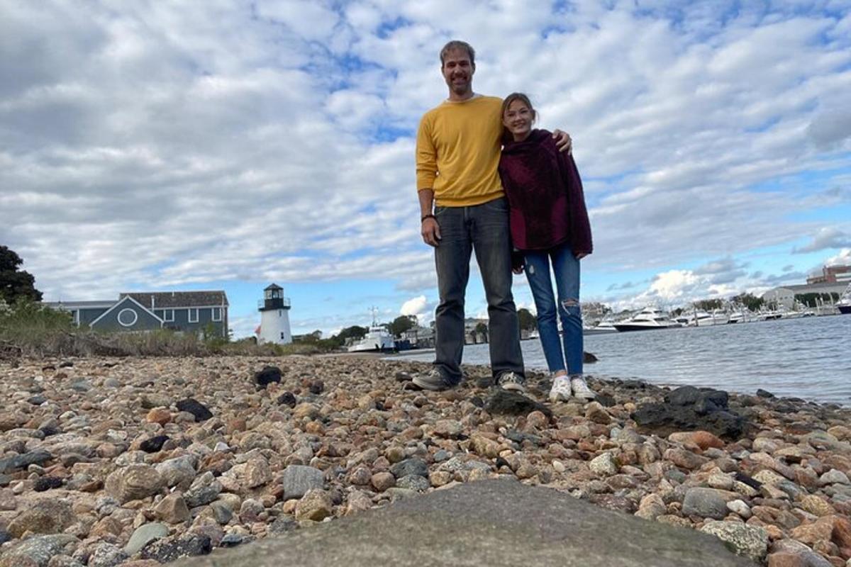 a man and a woman standing on a rocky beach