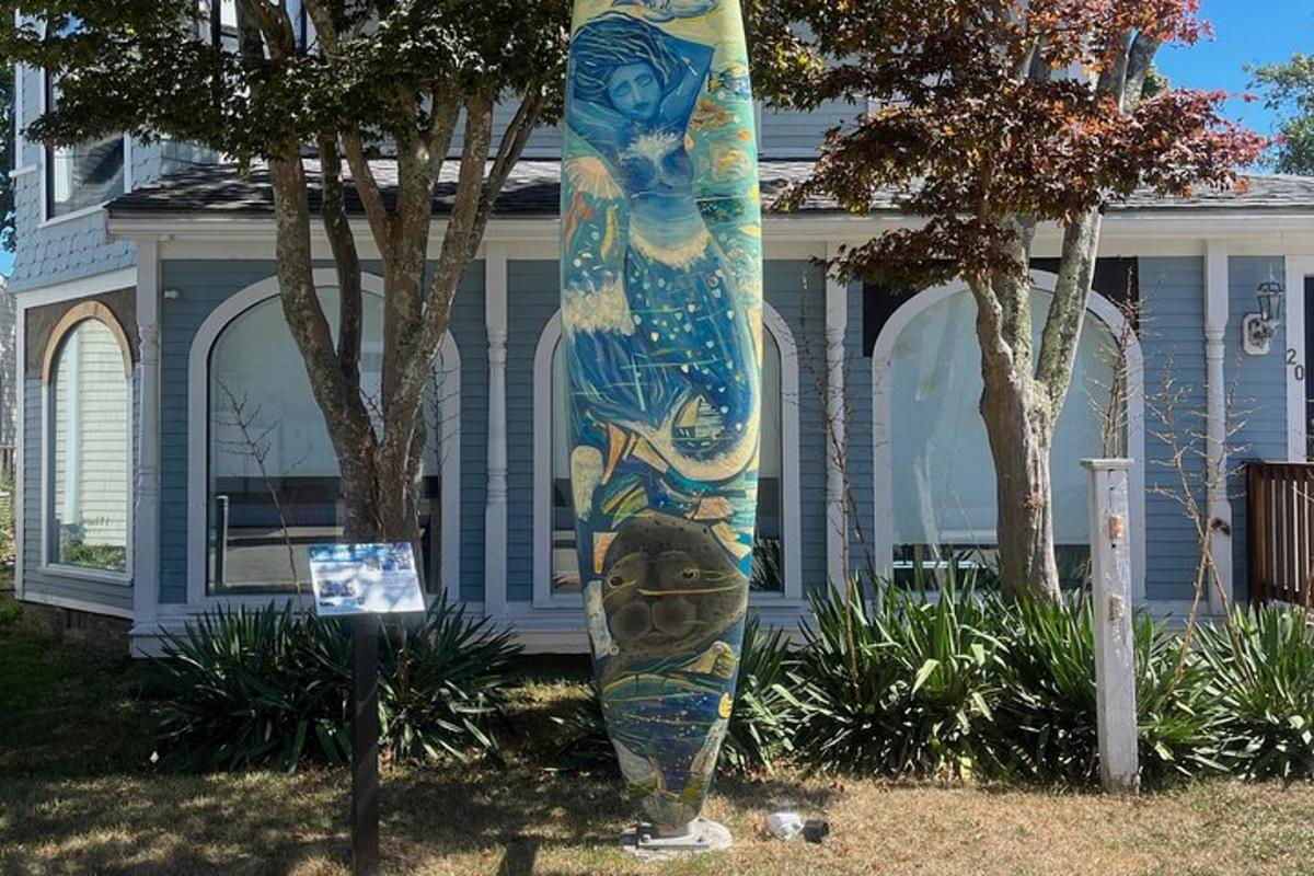 a surfboard on display in front of a house