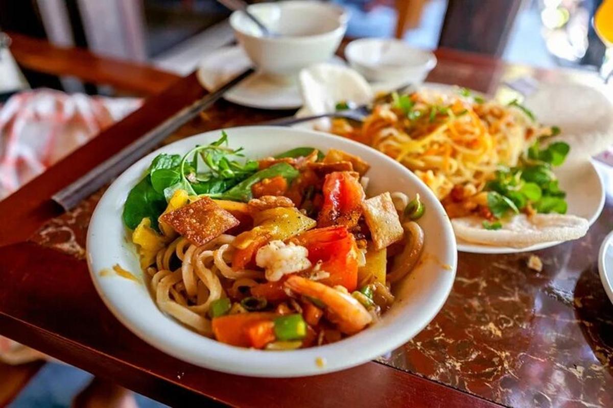 a plate of food with noodles and vegetables on a table