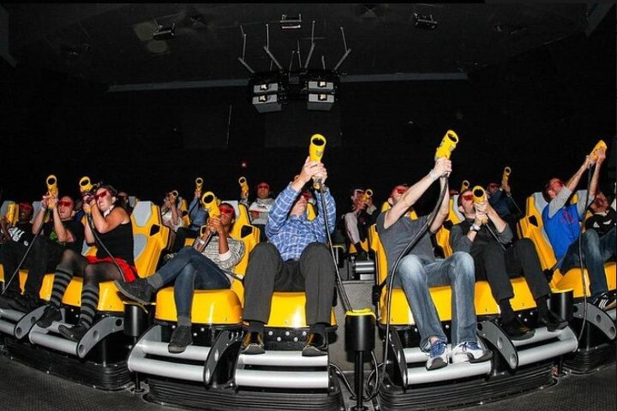 a group of people sitting in chairs with their hands in the air