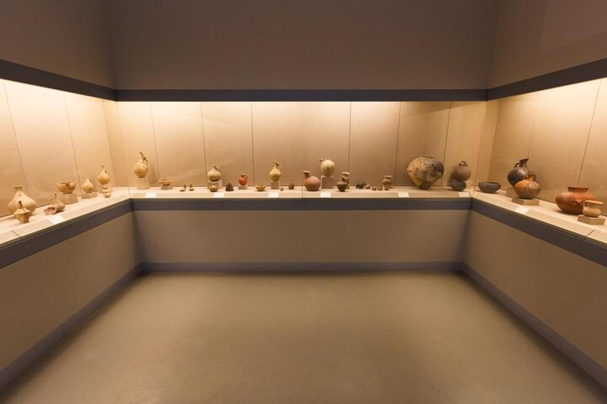 a room with vases on display in a museum