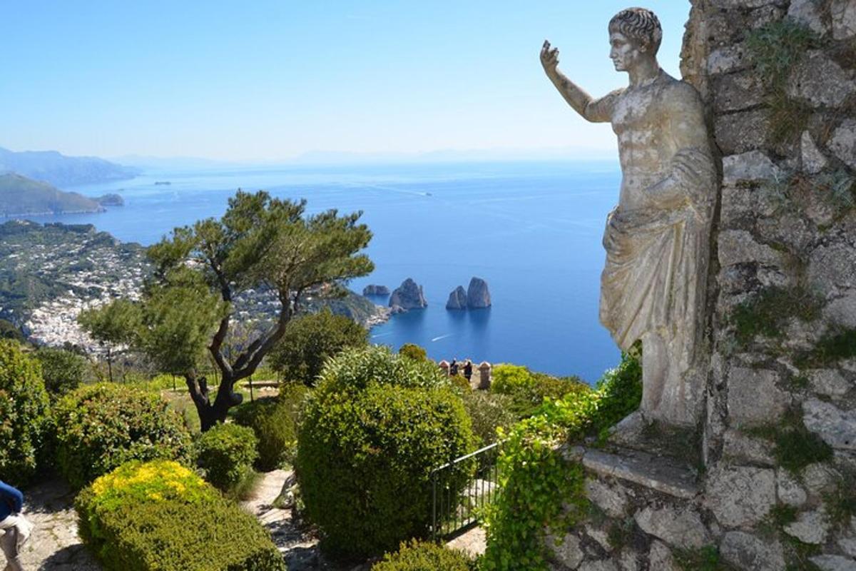 a statue of a woman standing on top of a wall