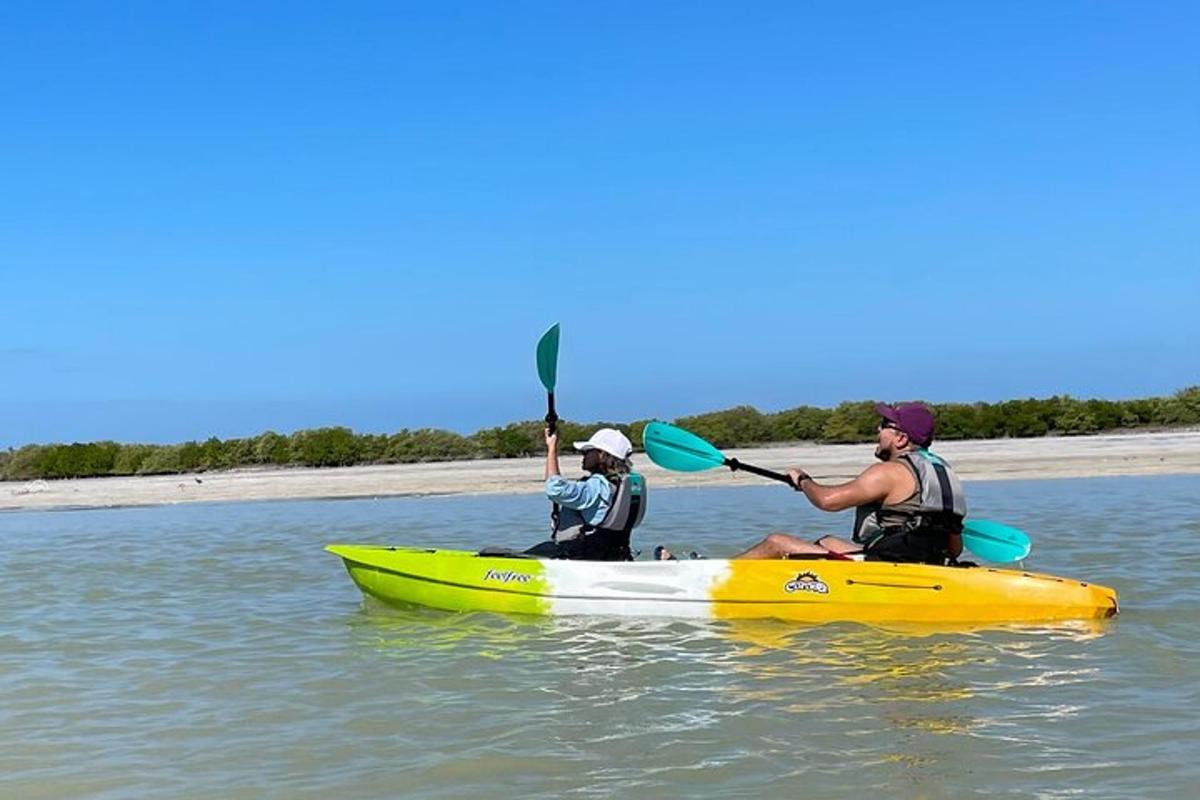 two people in a yellow kayak in the water