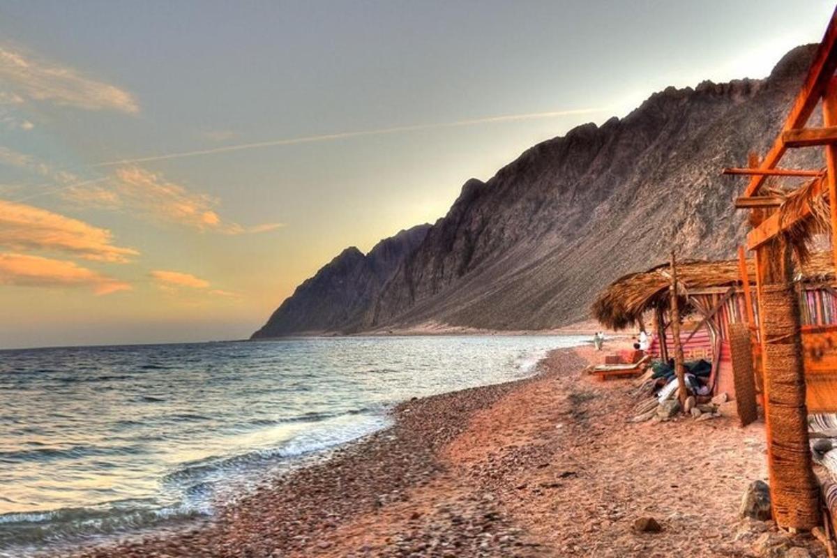 a beach with a hut and the ocean