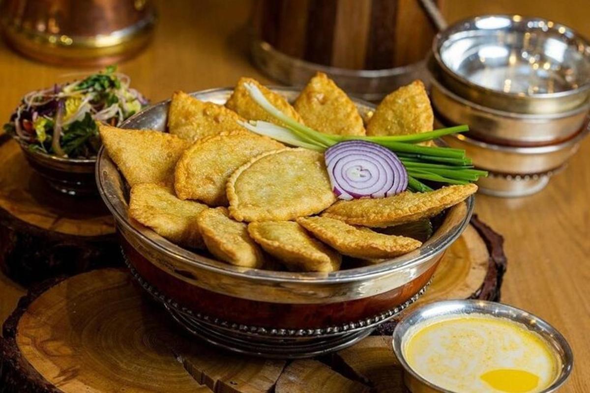 a bowl of chips and dip on a wooden table
