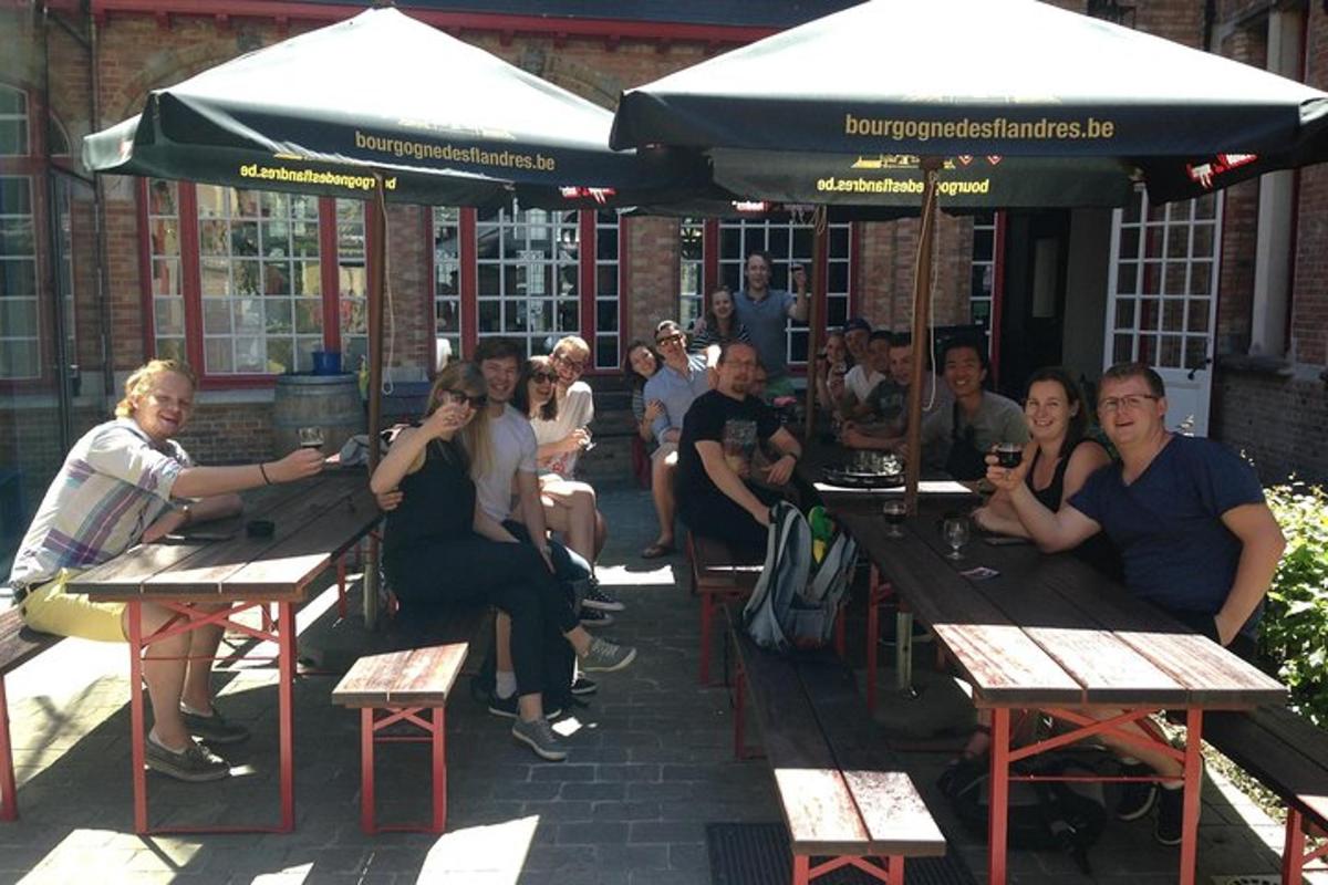 a group of people sitting at tables outside a restaurant