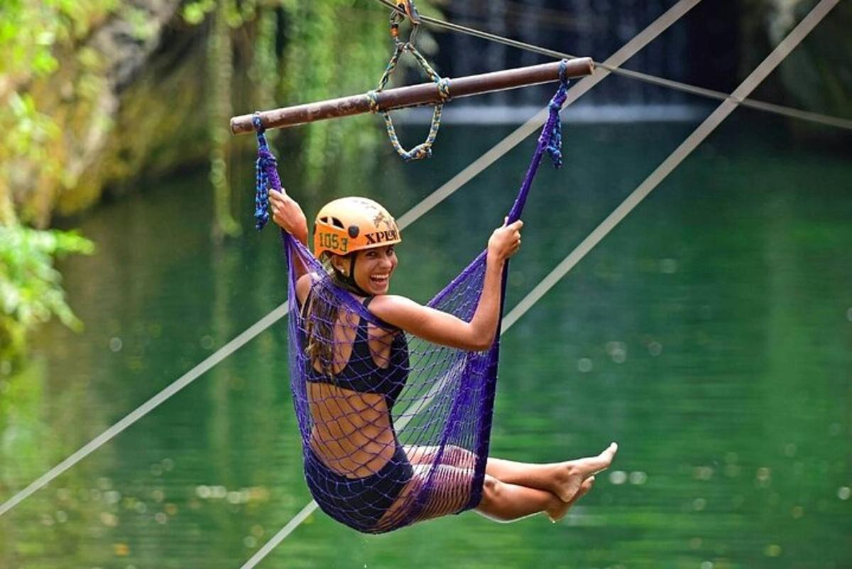 a woman is hanging on a rope swing