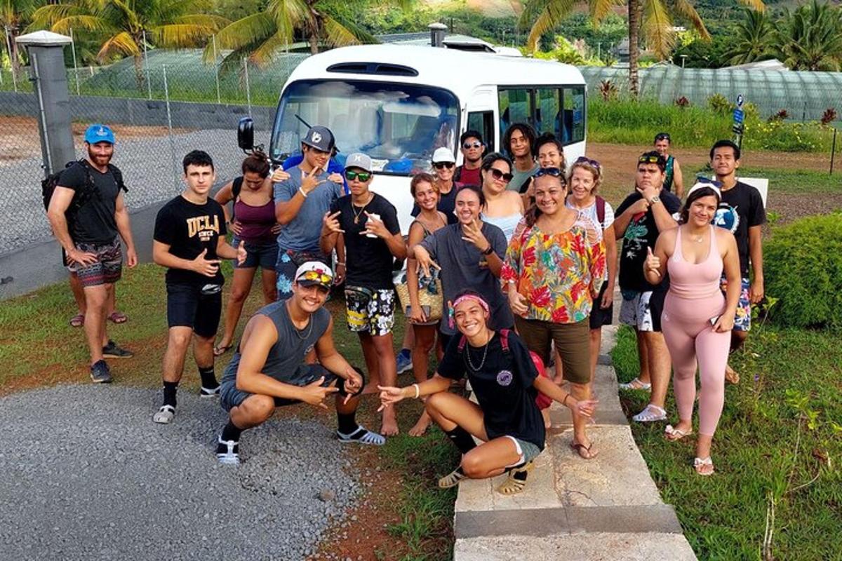 a group of people posing for a picture in front of a van