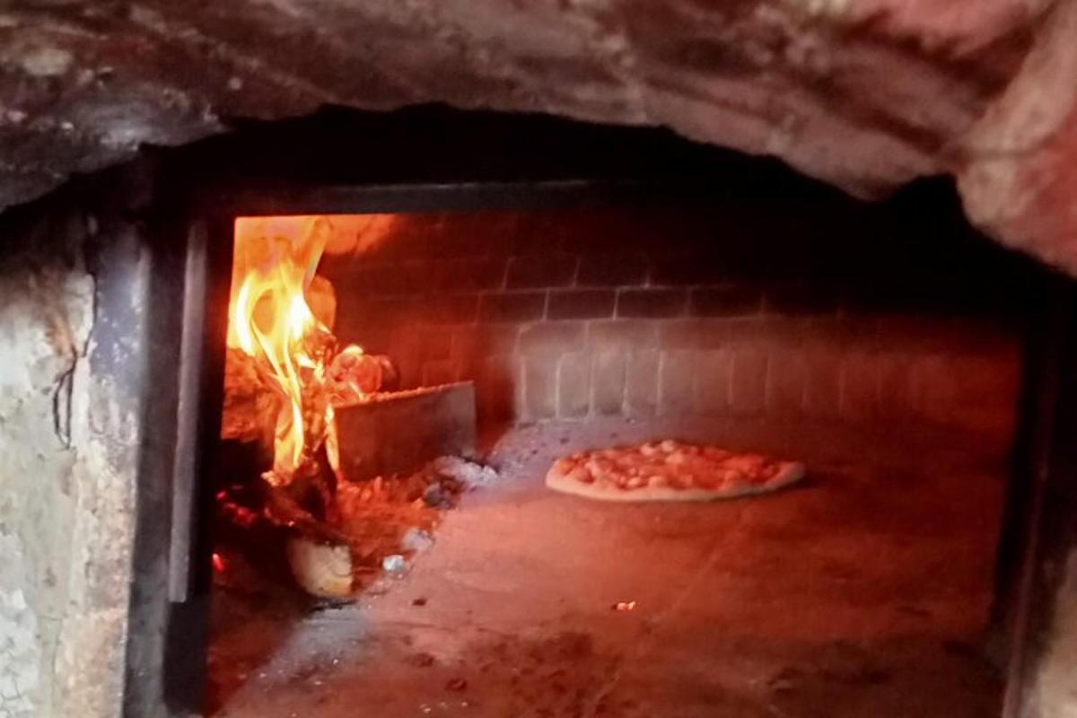 a brick oven with a pizza in it
