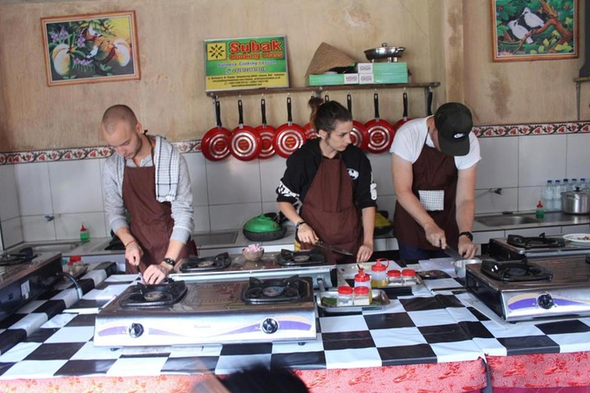 drei Männer in einer Küche bereiten Essen auf einer Theke zu