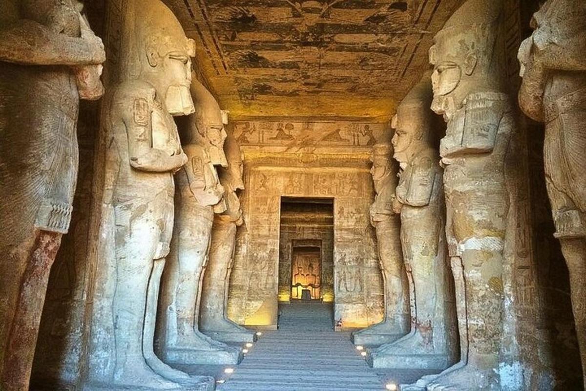 a hallway of a cave with statues in a temple