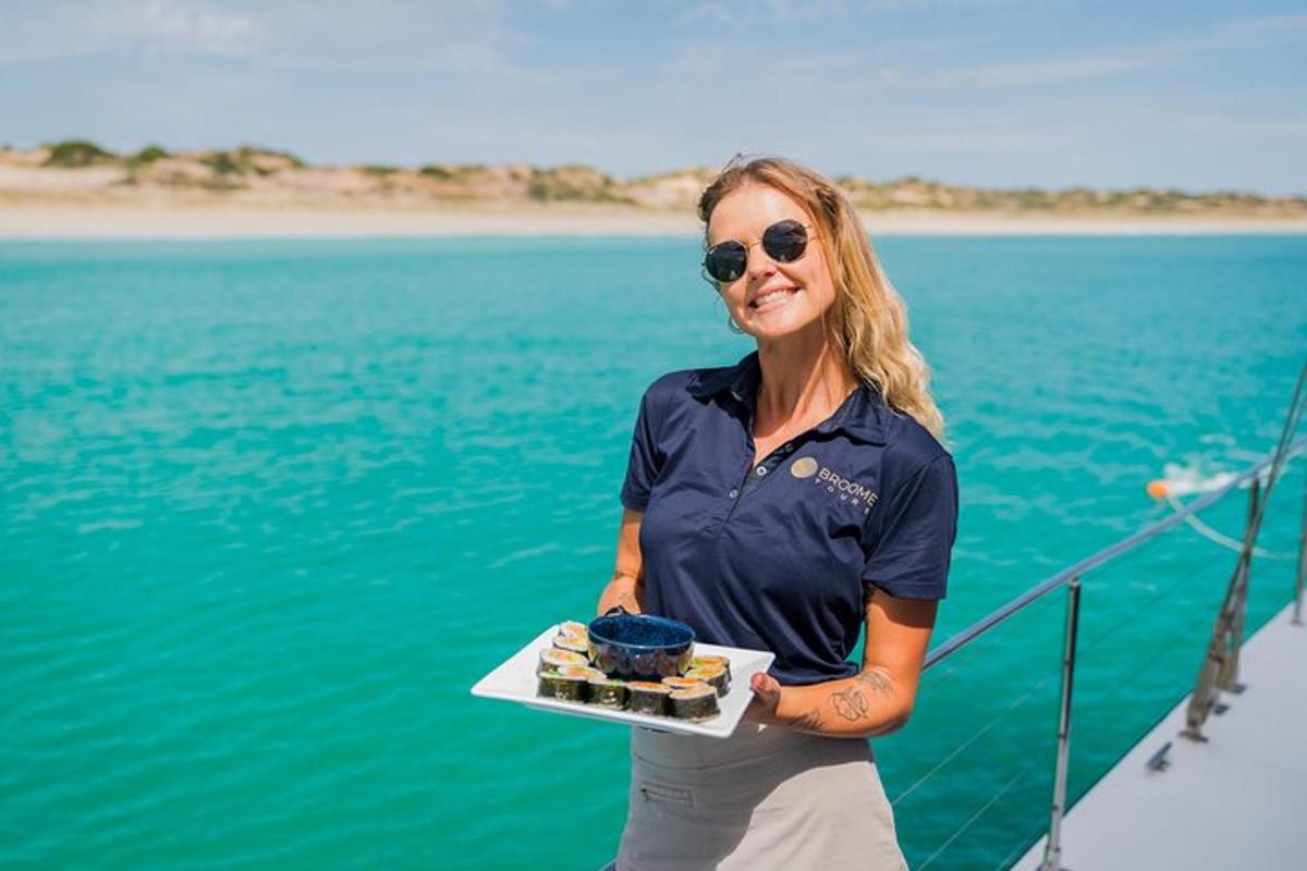 a woman holding a plate of food on a boat
