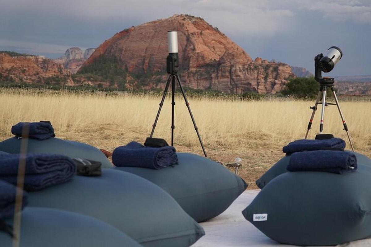 a group of cameras on tripod with a mountain in the background