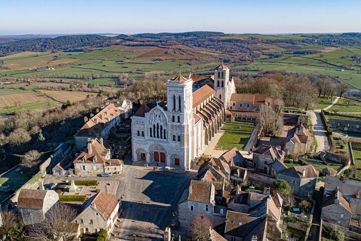 an aerial view of a church in a village