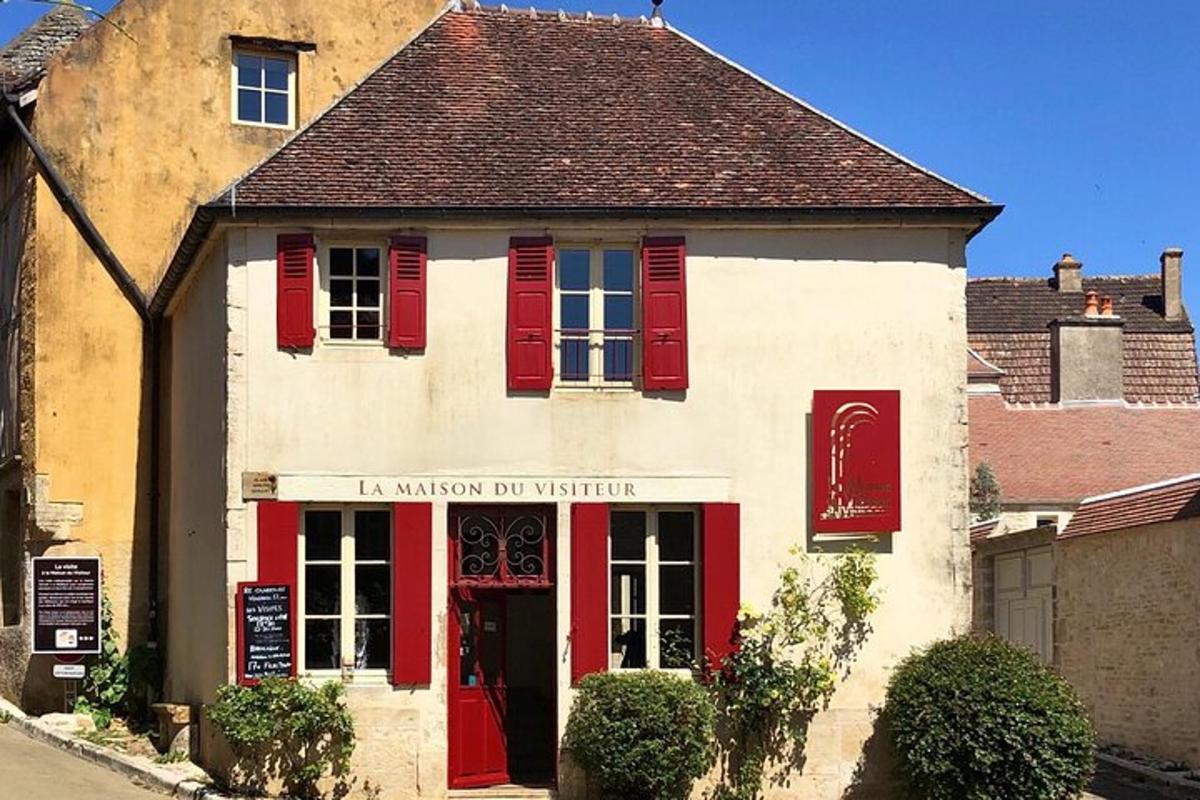 a white building with red shutters on it
