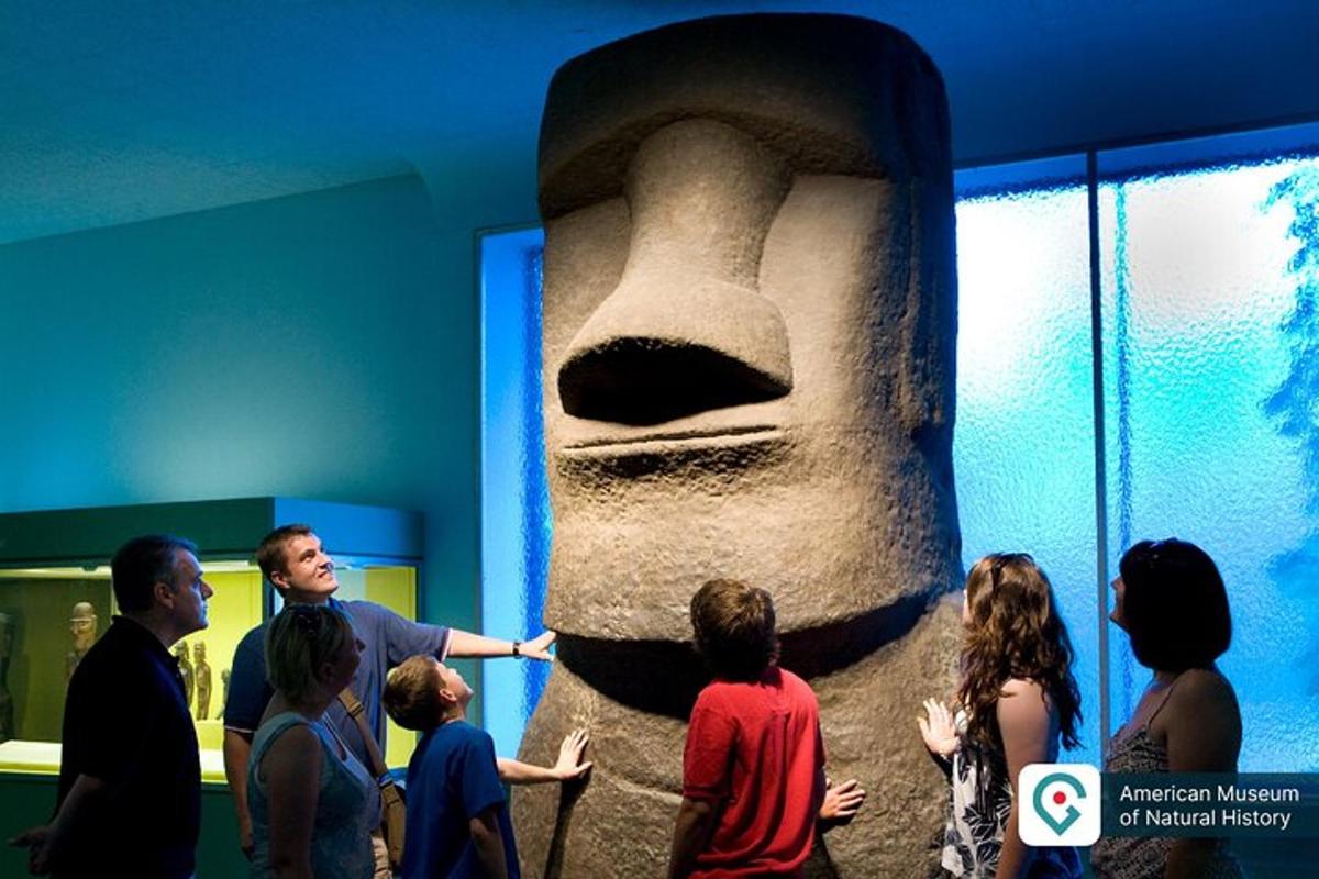 a group of people looking at a statue in a museum