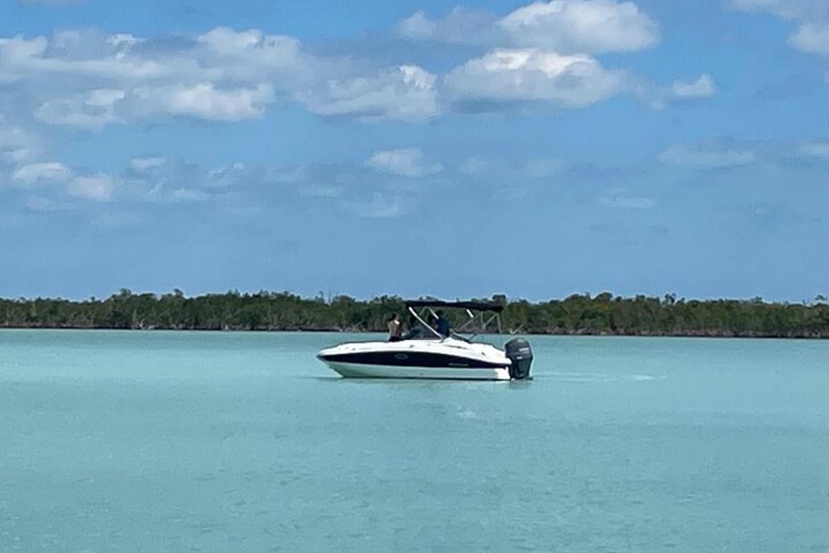a boat sitting in the middle of a lake