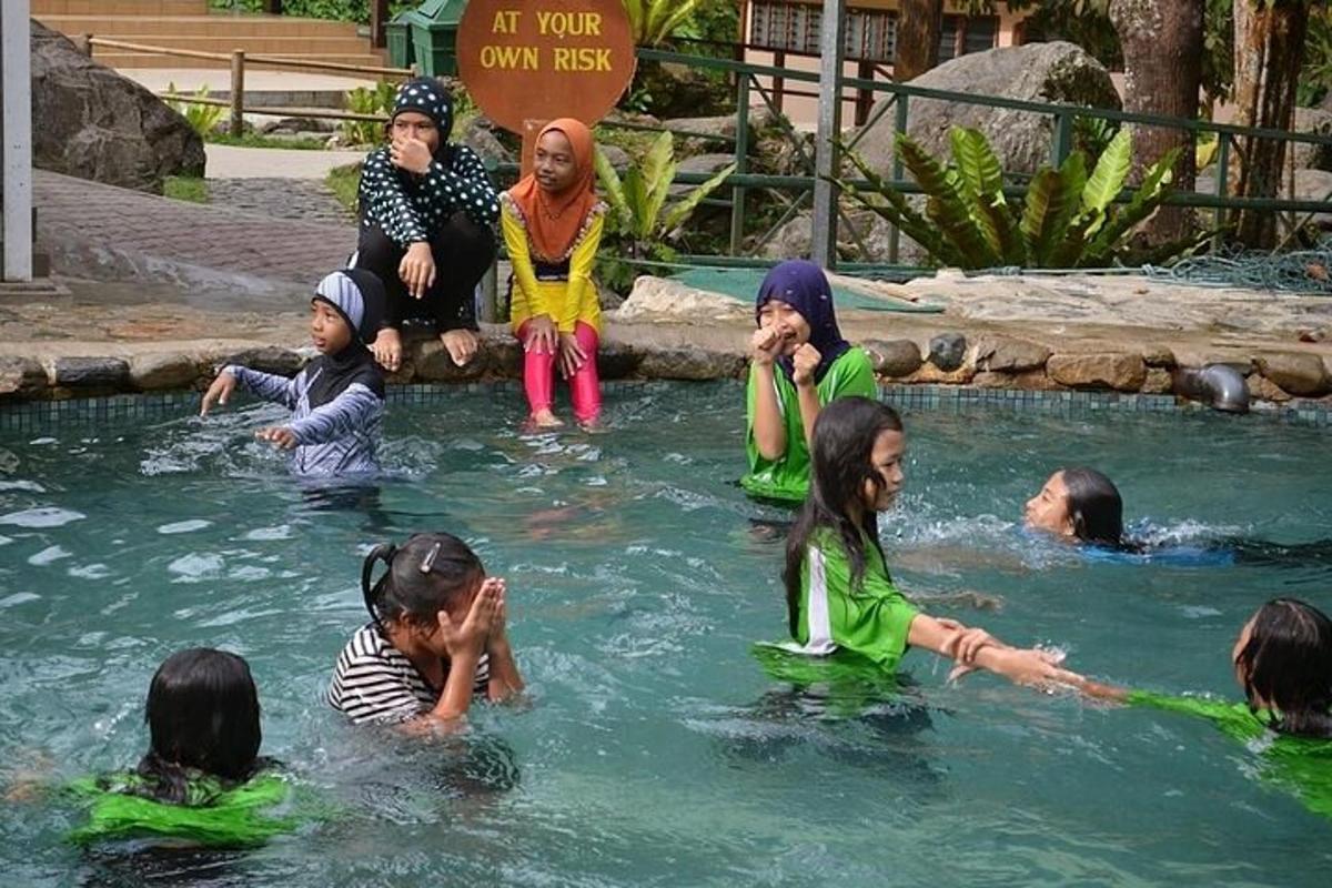 a group of children playing in the water in a pool
