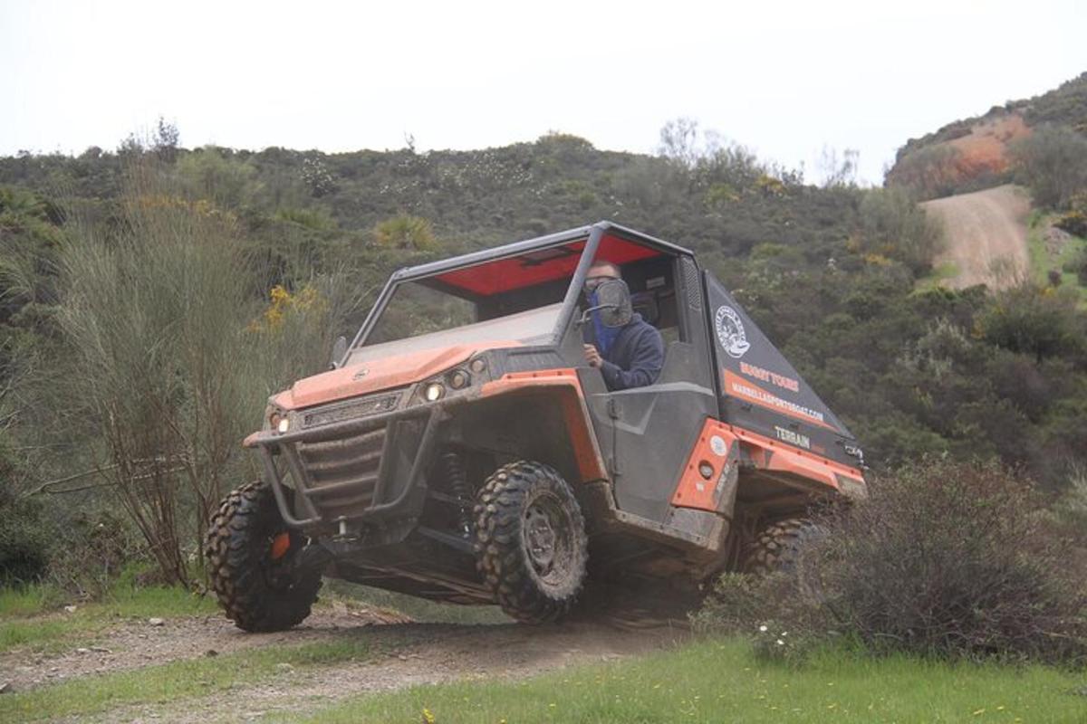 a person in a jeep driving on a dirt road