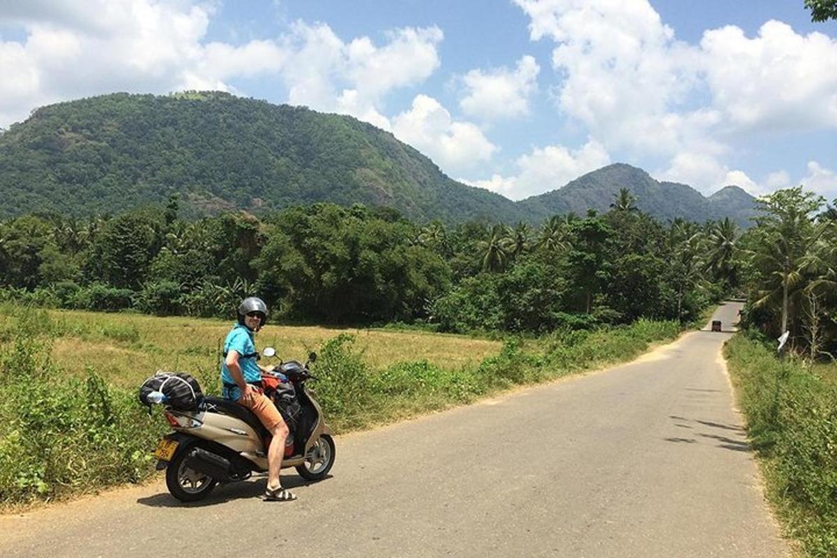 a man sitting on a motorcycle on a road
