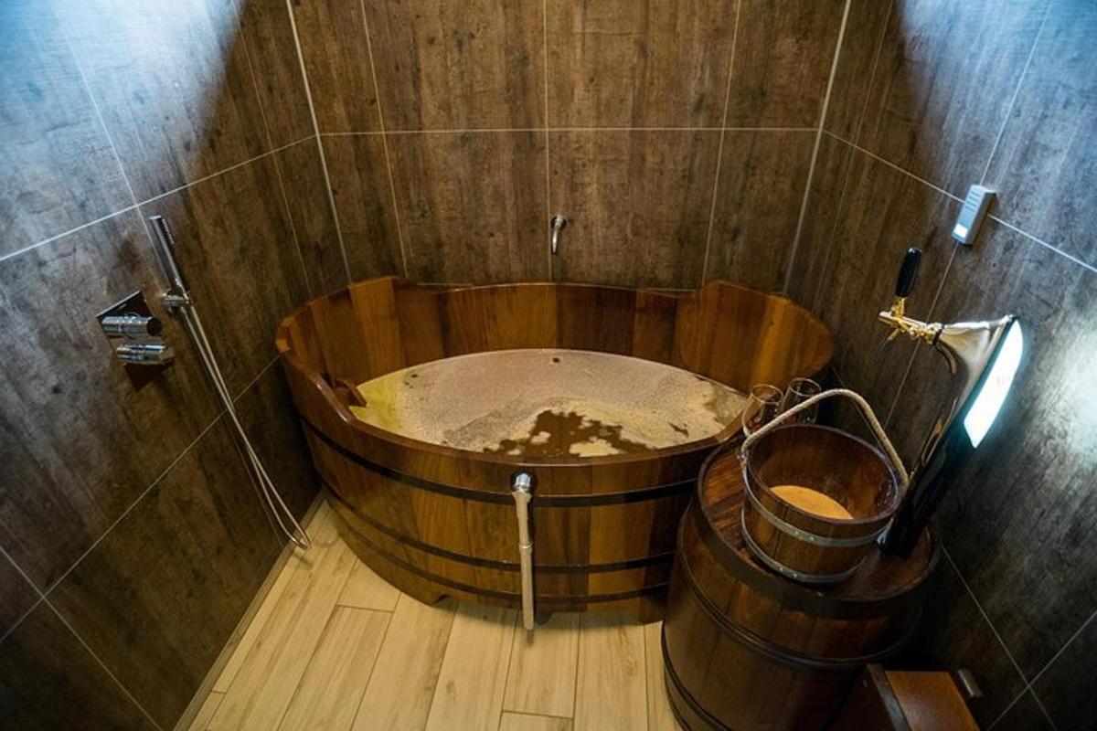 a bathroom with a large wooden tub in a room