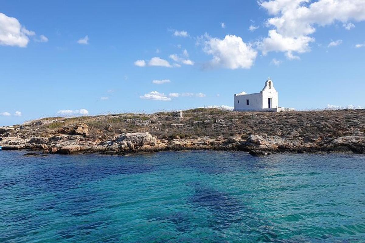 a white lighthouse on an island in the ocean