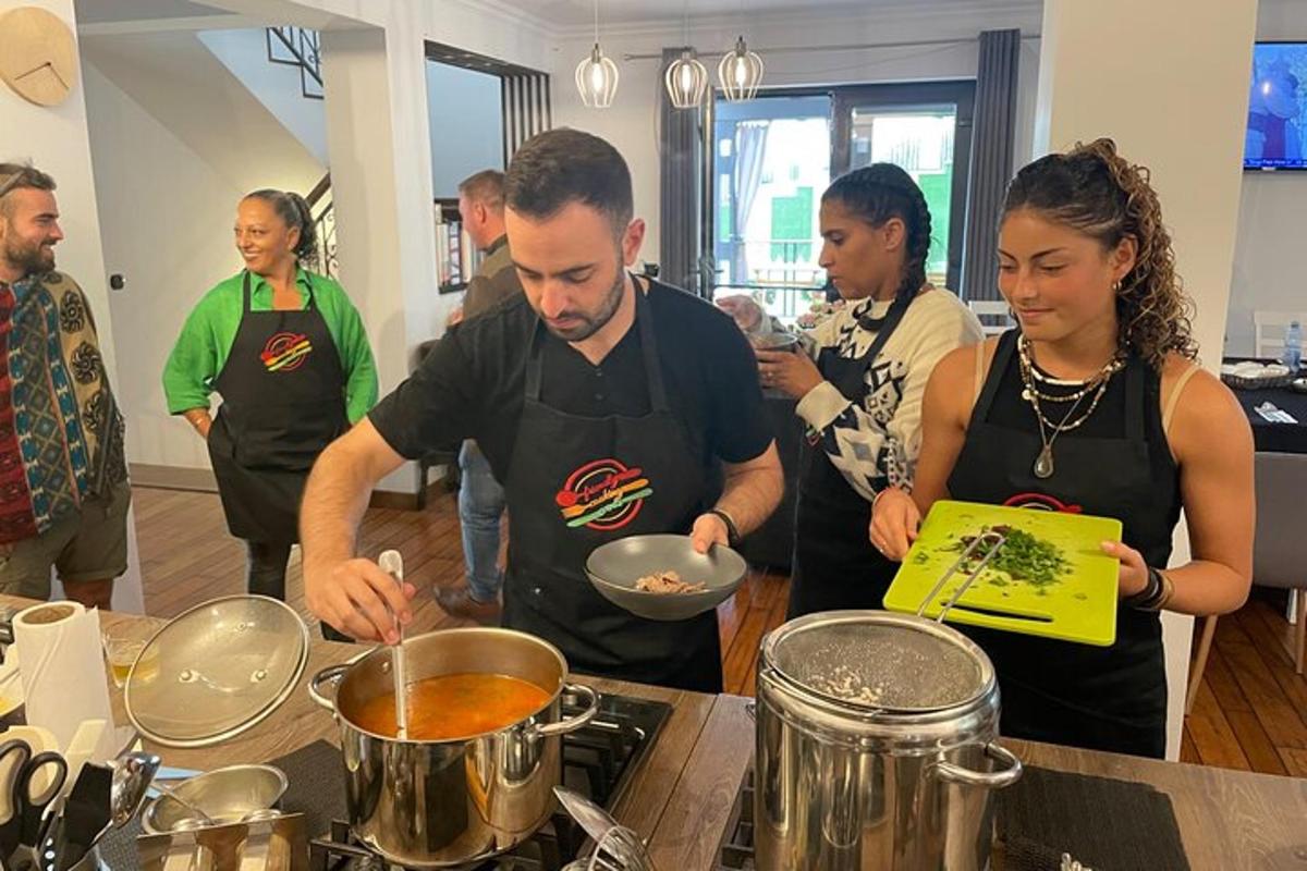 a group of people standing in a kitchen preparing food