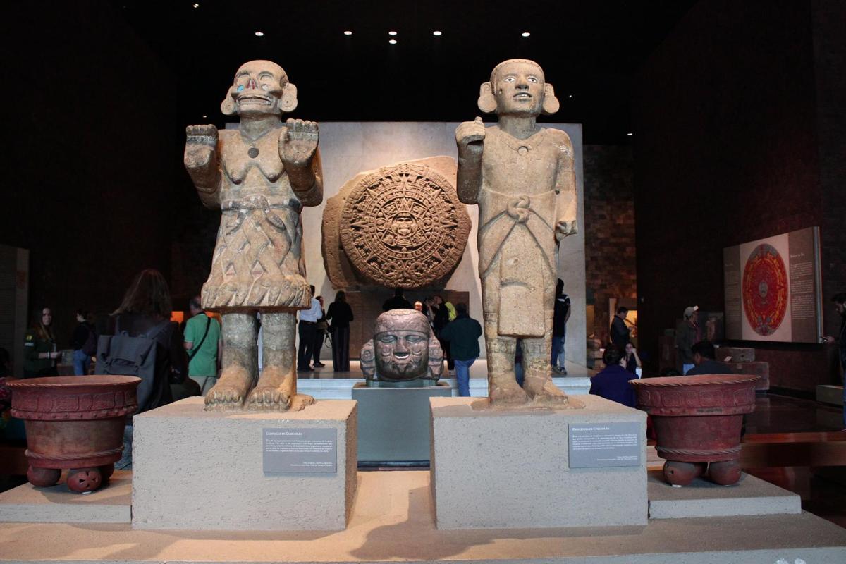 two statues of two people on display in a museum