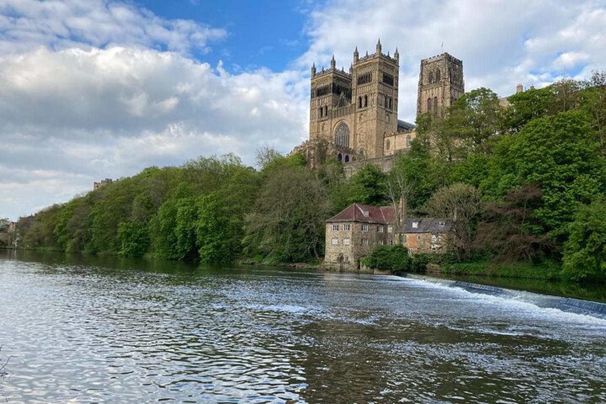 a castle sitting on a hill next to a river