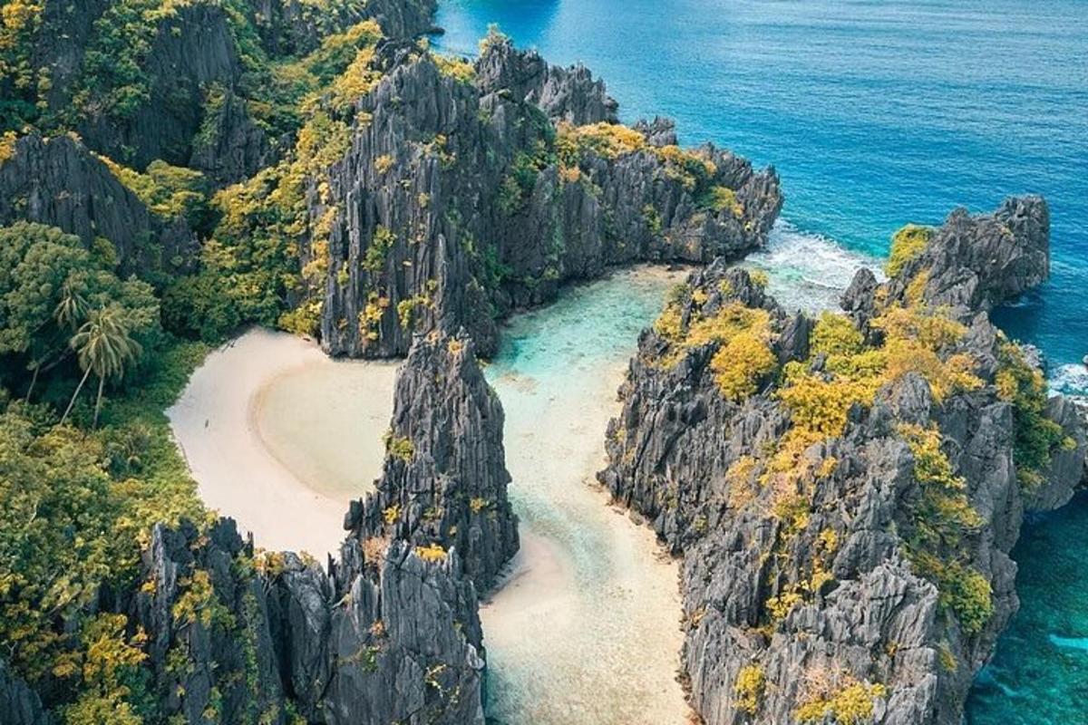 an aerial view of a rocky island with a beach