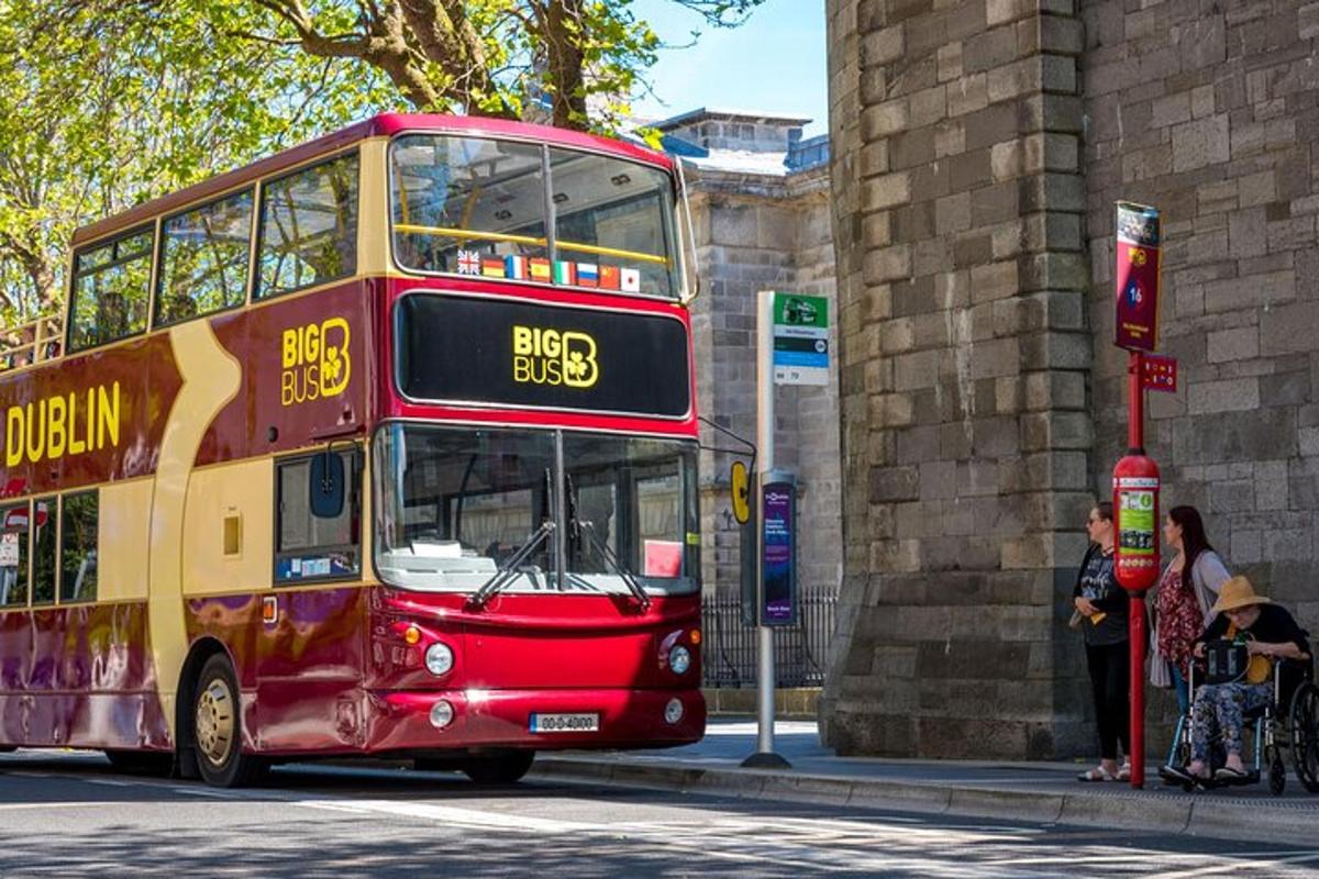 a red double decker bus on a city street