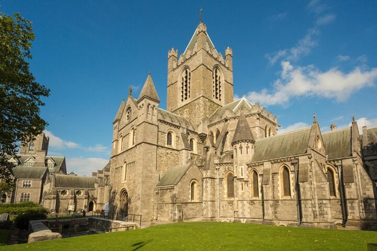 a large stone church with a tower on a grass field