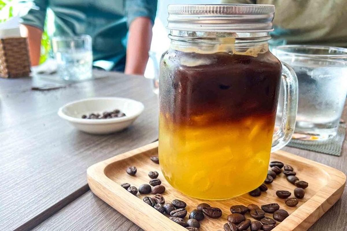 a jar of honey and coffee beans on a wooden table