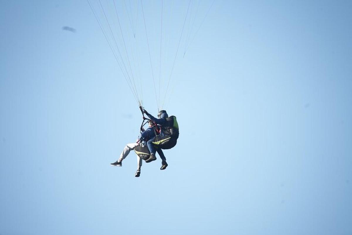 a man on a paraglider in the sky