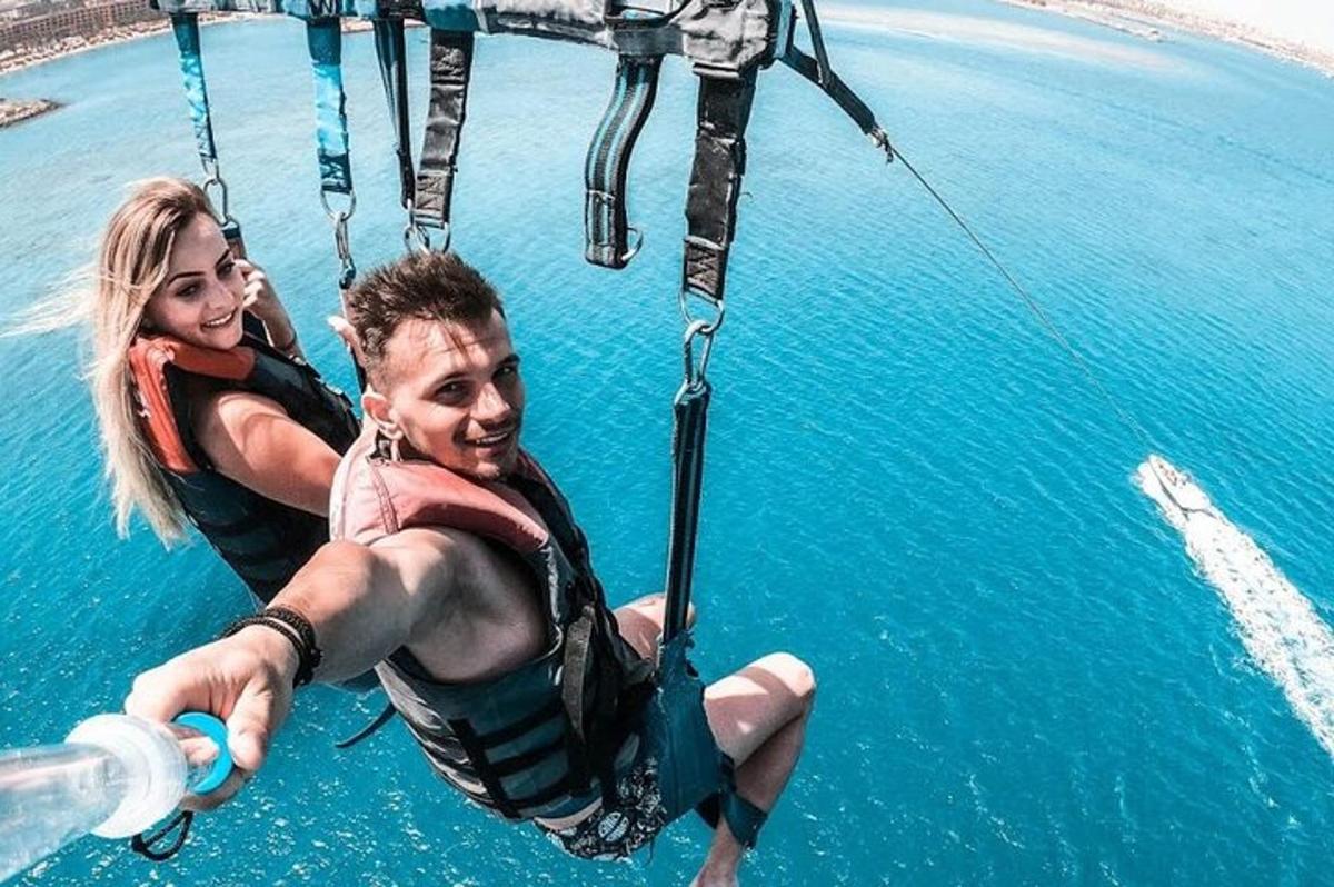 two people in the water on a rope swing in the water