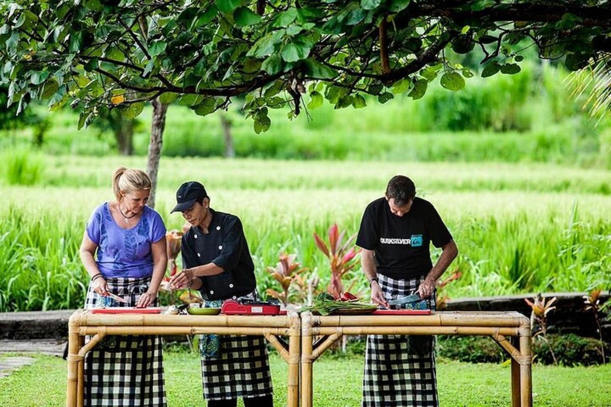 a group of three people preparing food on a table
