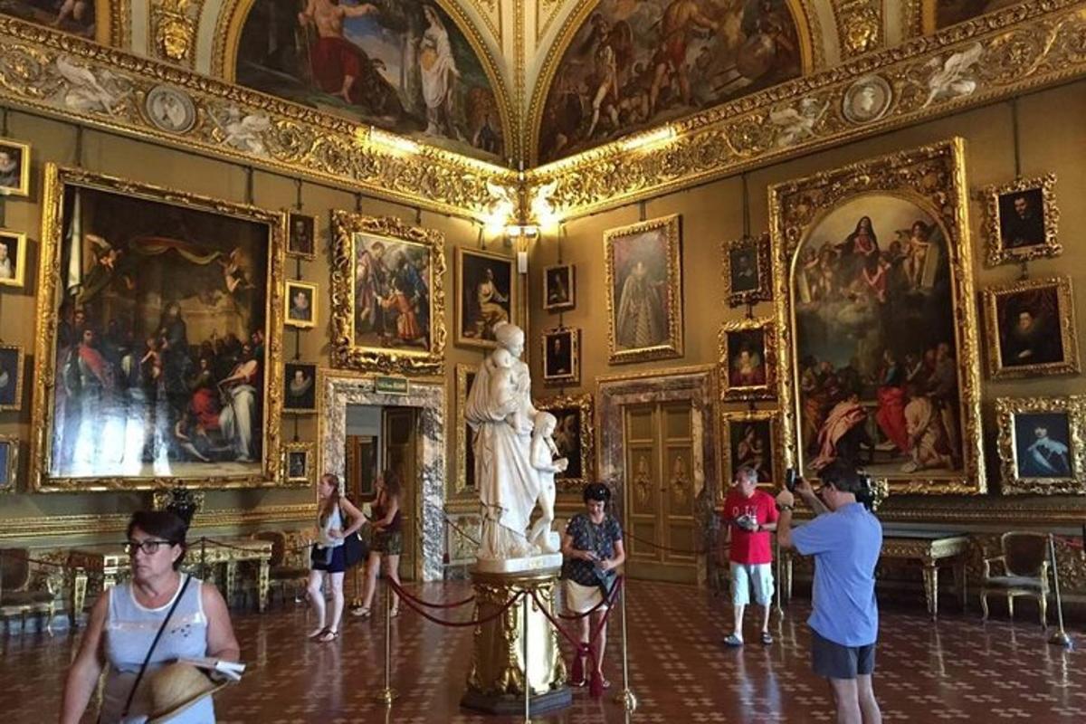 a group of people in a room with a statue in a museum