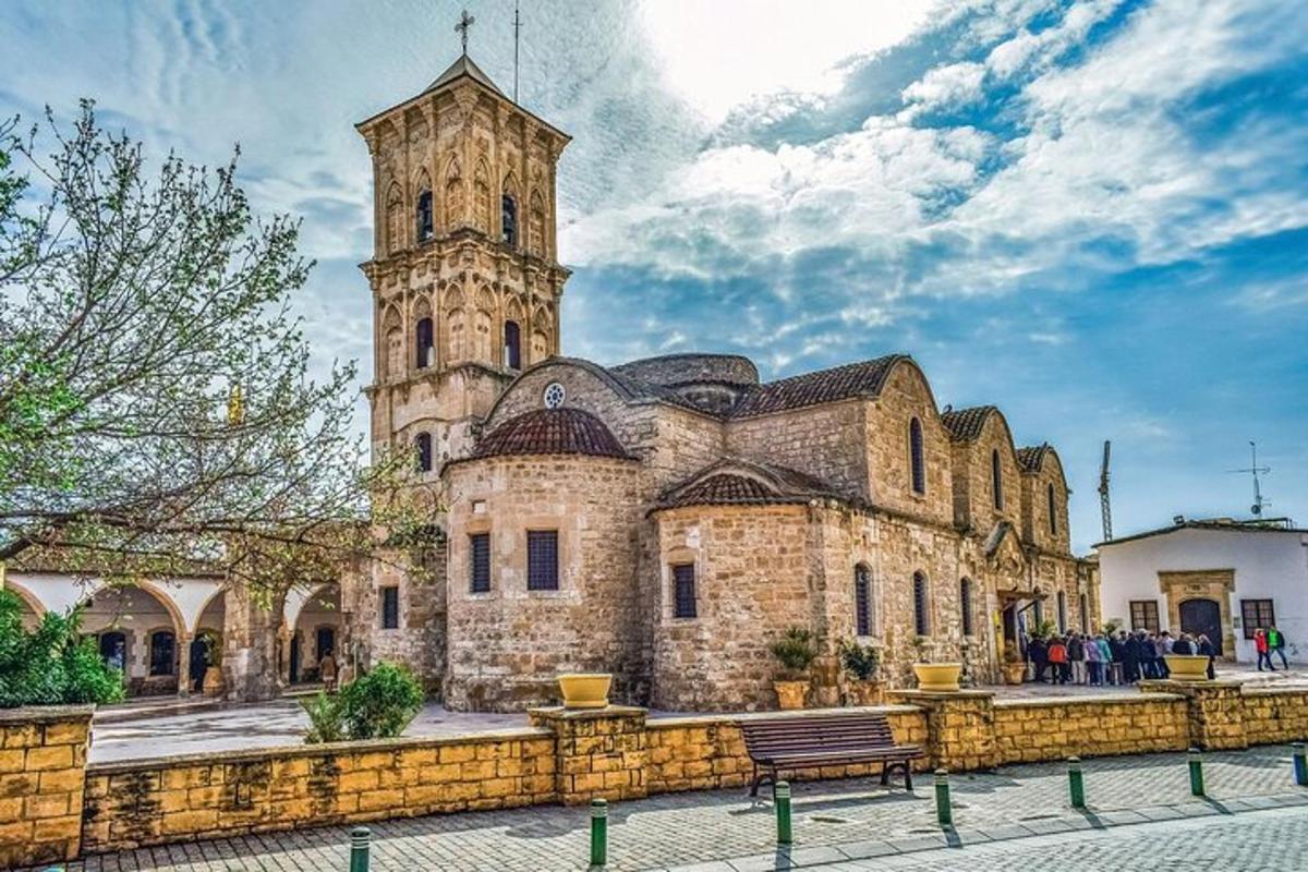 an old building with a clock tower and a bench