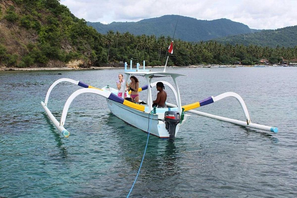 a group of people on a boat in the water