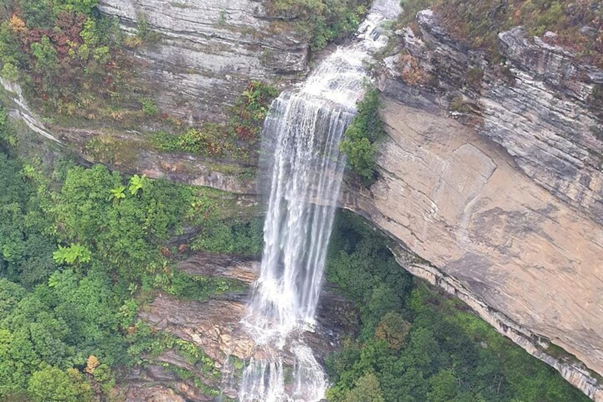 an aerial view of a waterfall on a rock