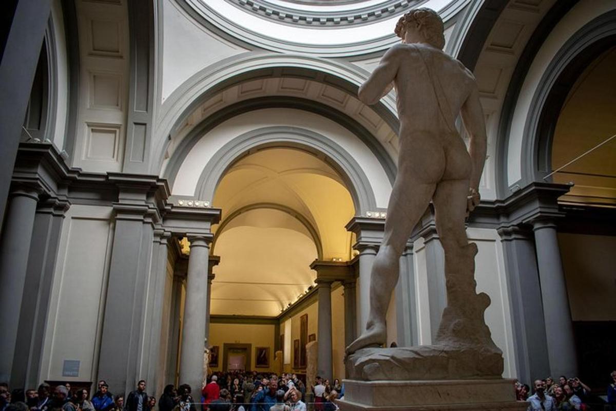 una statua in un edificio con una folla di persone