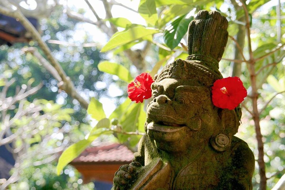 a statue with two red flowers on its head