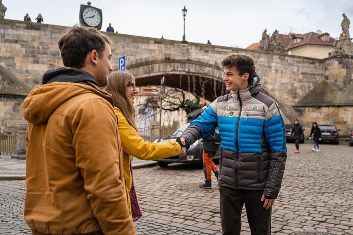 two men shaking hands on a street with a woman