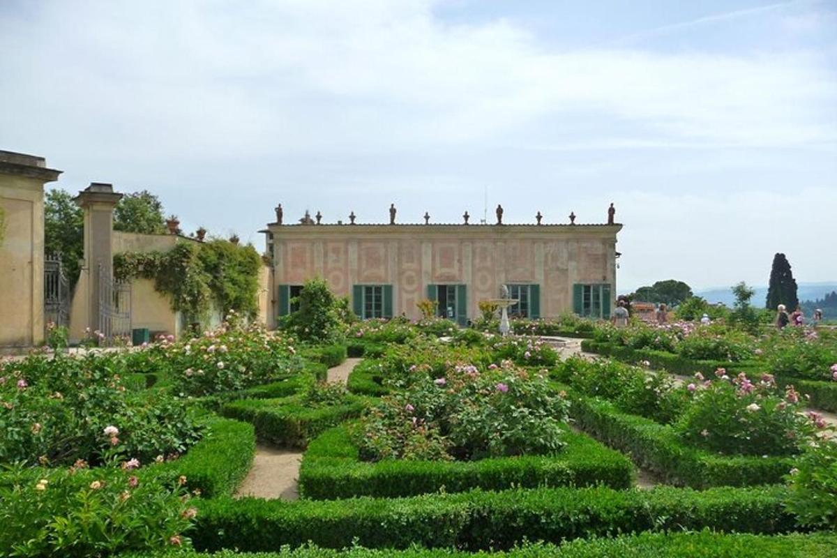 a garden in front of a building with bushes and flowers