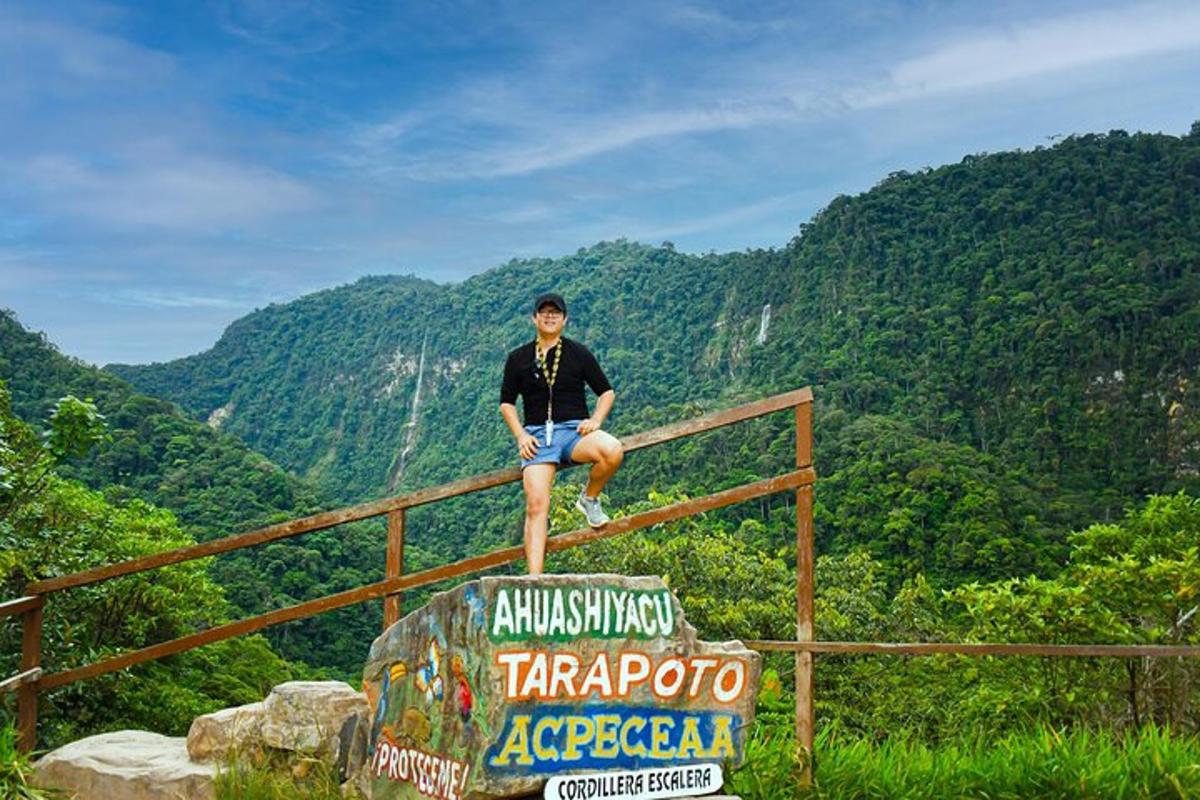 a man sitting on top of a fence