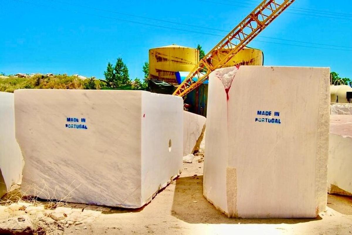 two concrete barriers with writing on them in front of a crane