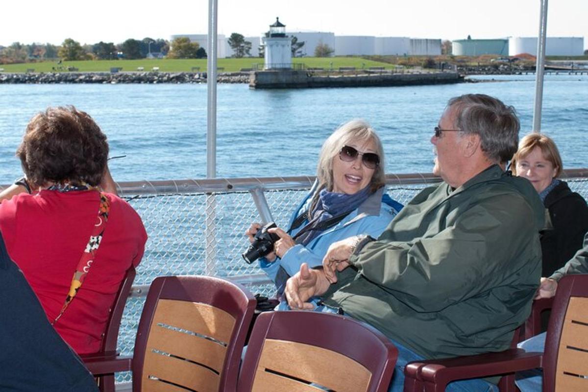a group of people sitting on a boat in the water
