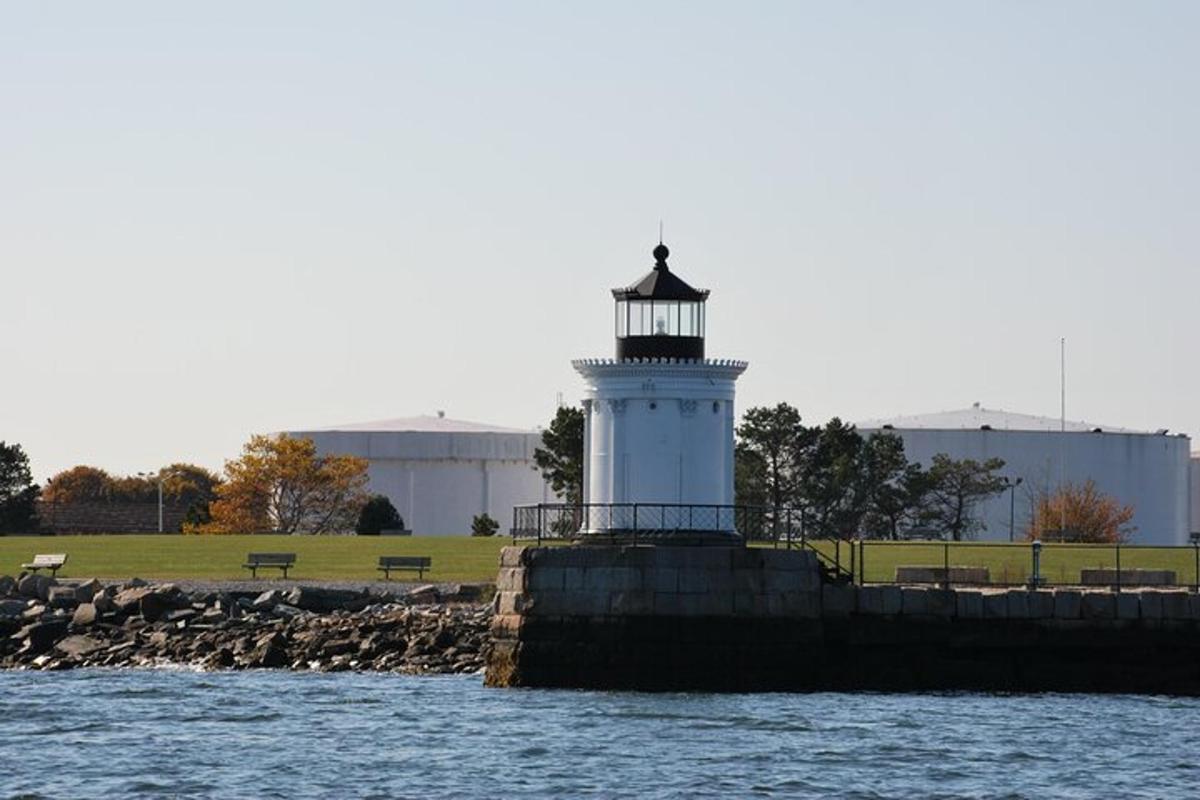 a lighthouse sitting on the side of a body of water
